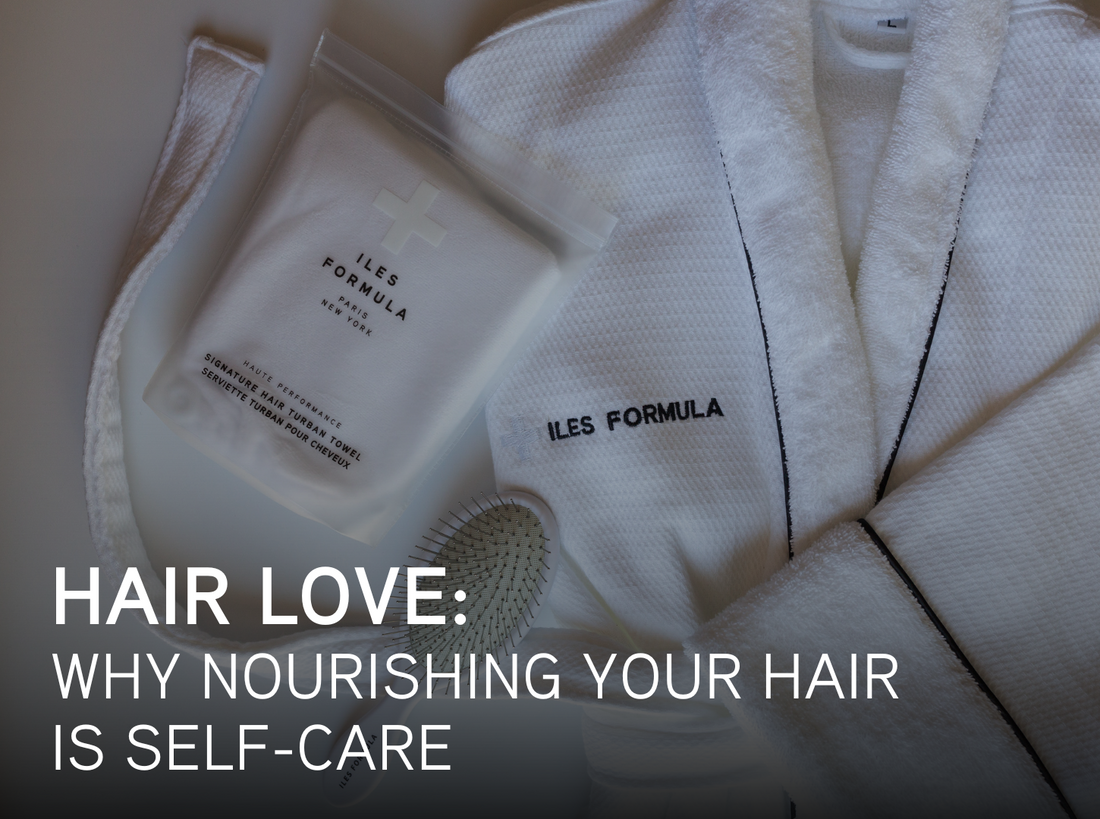 Flat lay of Iles Formula haircare sachet, a white robe, and a brush, with text overlay that reads: “Hair Love: Why nourishing your hair is self-care.”