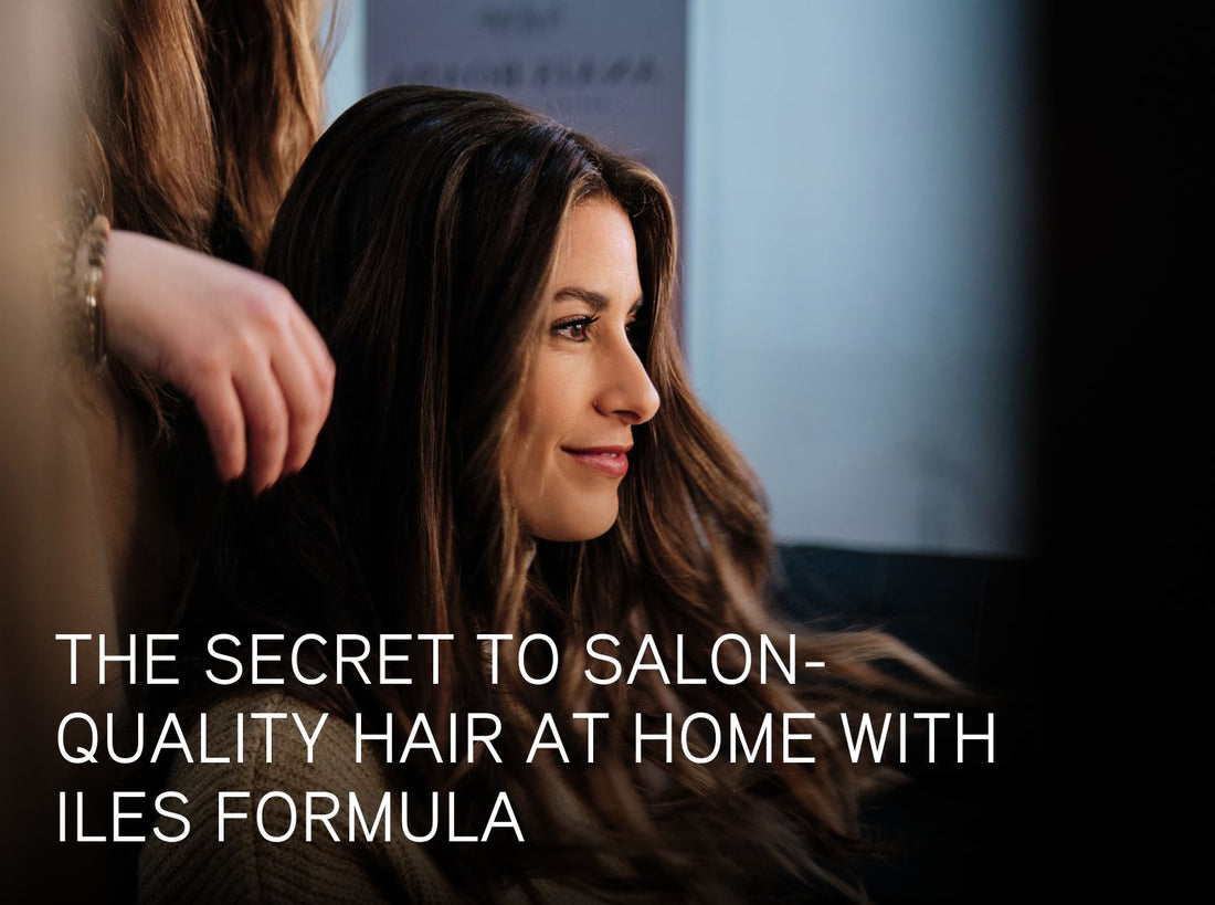 Smiling person with long, shiny hair in a salon setting, with text overlay that reads: “The secret to salon-quality hair at home with Iles Formula.”