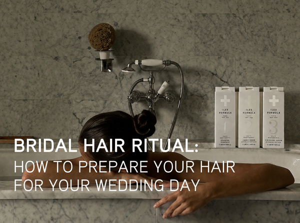 Woman relaxing in marble bath with Iles Formula Shampoo, Conditioner, and Finishing Serum — the bridal hair ritual by Iles Formula