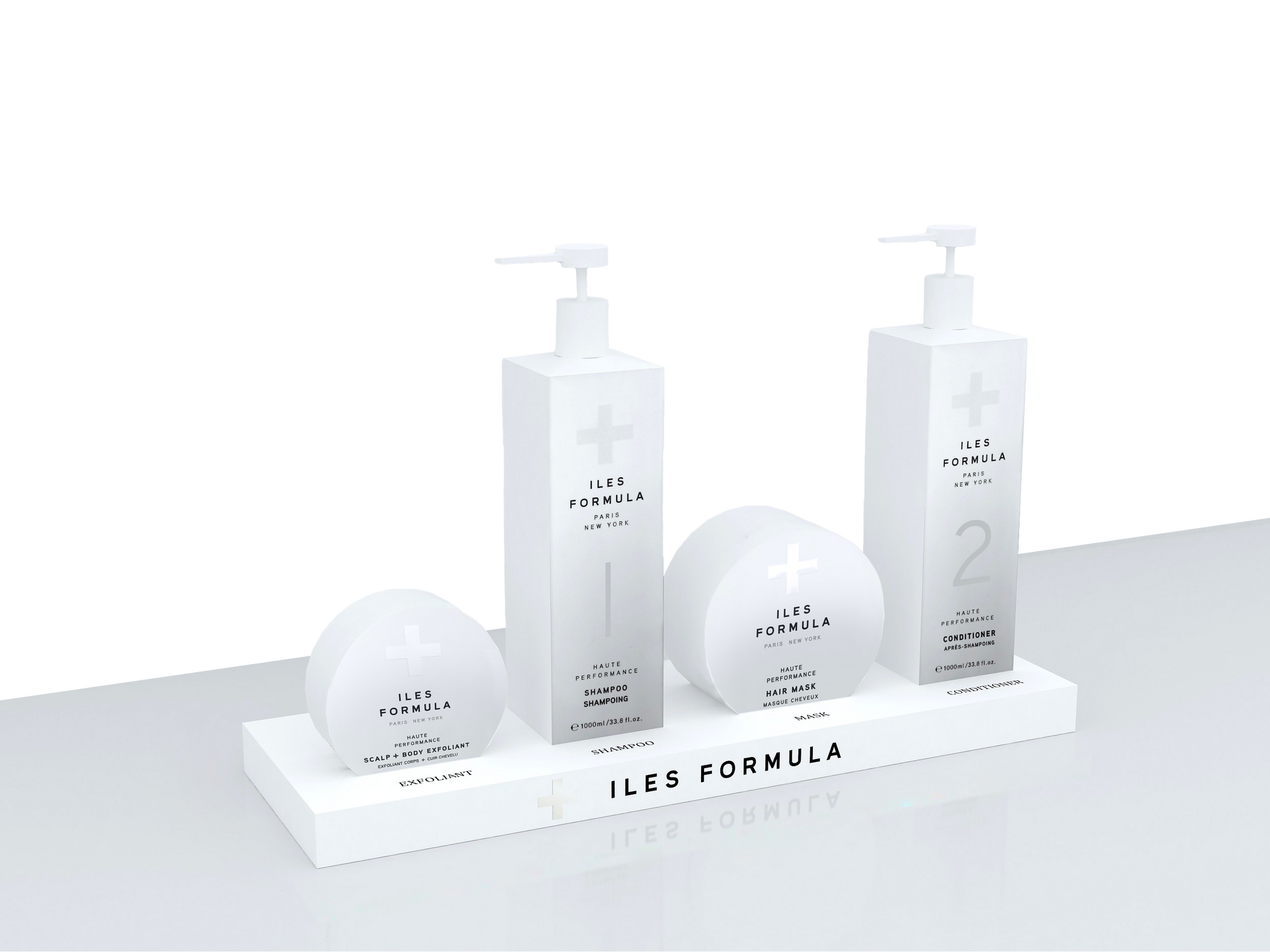 A white backbar display stand with two bottles, one labeled 'HAIR LOSS TREATMENT' and the other 'HAIR GROWTH TREATMENT', and a round sign with 'ILES FORMULA' branding.