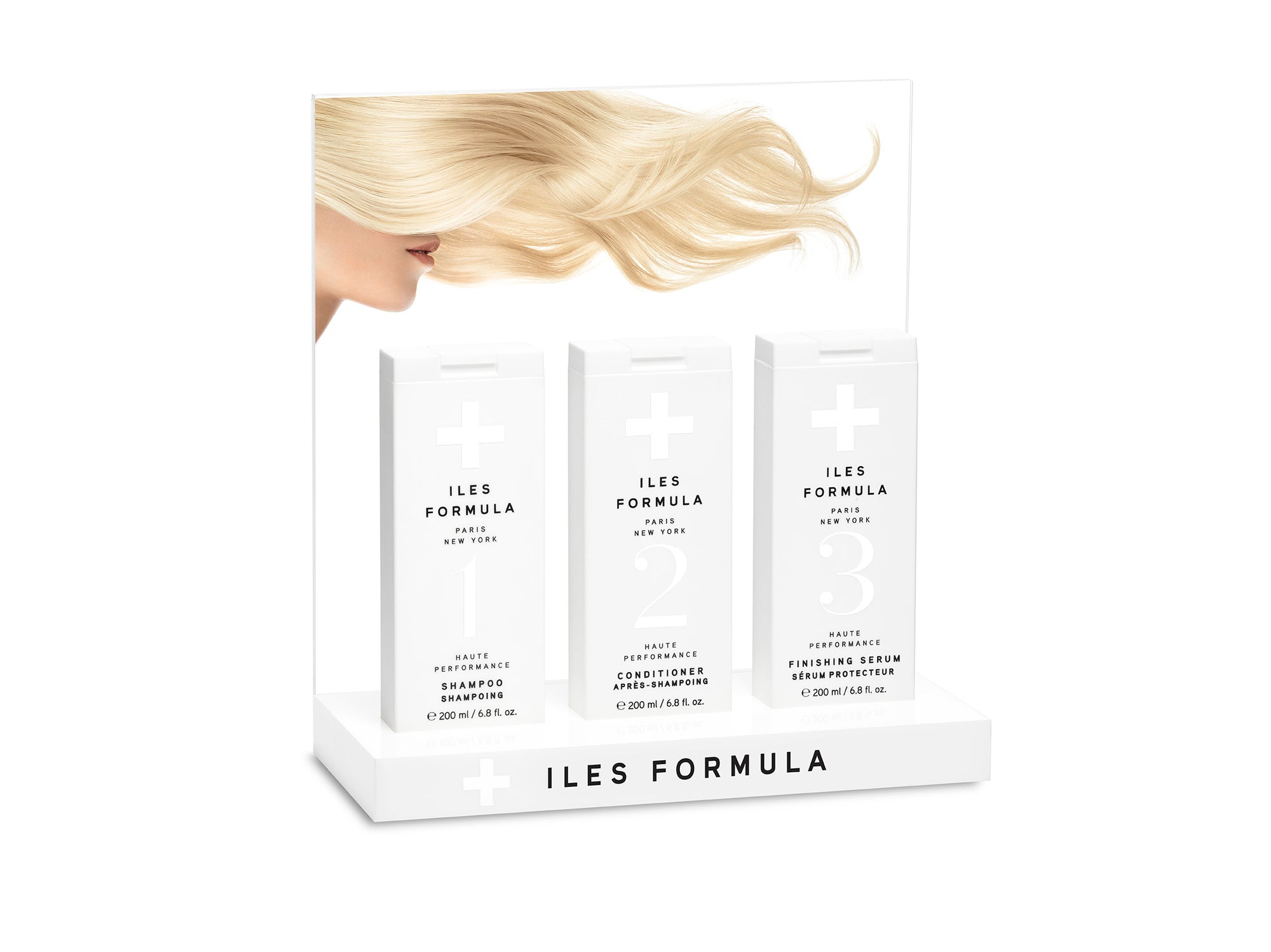 A custom acrylic display stand with packaged hair product boxes on it, designed to showcase the product to potential buyers.