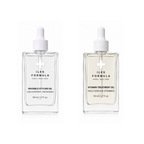 Two clear glass dropper bottles of Iles Formula Paris New York skincare oil on a white background. The left bottle is Invisible Styling Oil, and the right bottle is Vitamin Treatment Oil.