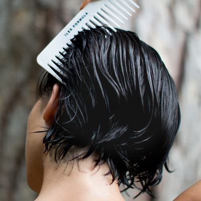 Conditioner Distribution Comb Brushing Through Short Dark Hair